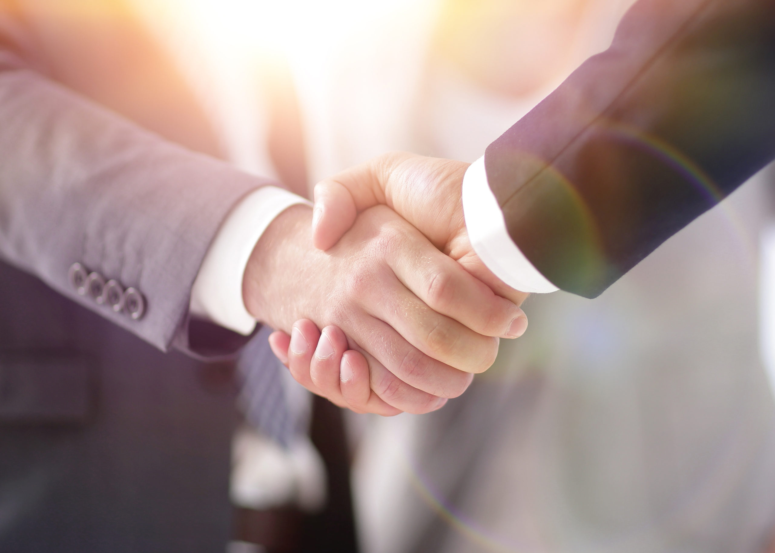 Two people shaking hands to agree a deal | Chambers and Partners